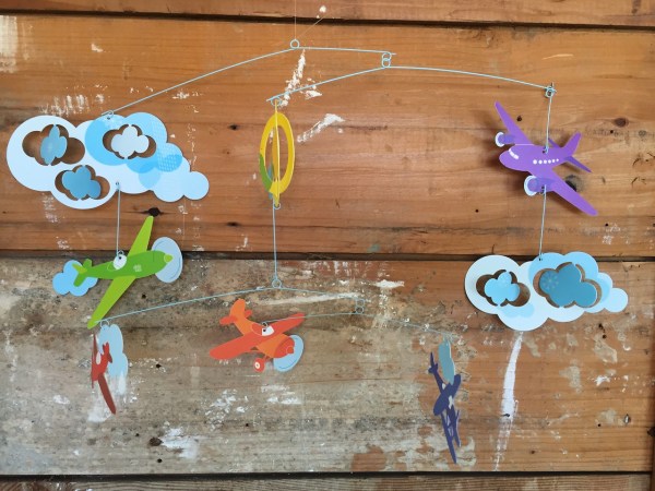 Djeco Mobile planes flights of fancy against wooden backdrop