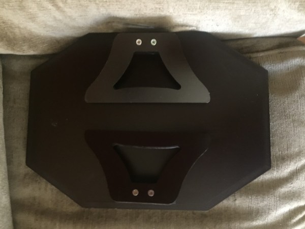 Wooden sofa arm clip table with legs folded up and underside shown