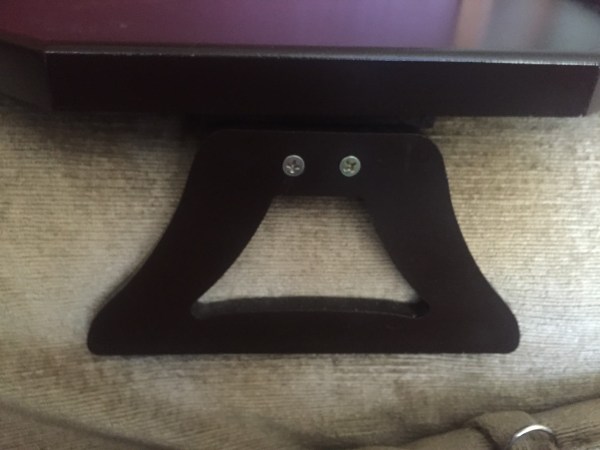 Sofa arm clip table leg shown installed on couch arm