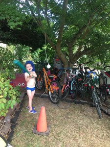 Child hitting ball on string in front yard wearing underwear