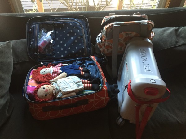 Suitcase and pile of belongings for trip