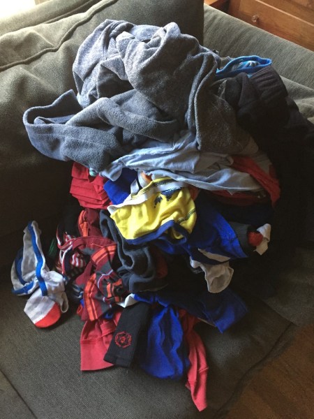 One pile of child's laundry on sofa