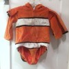 Nemo clownfish costume Disney bodysuit orange fabric with eyes on hood shown on hanger