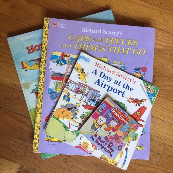Richard Scarry books in a stack including Cars and Truck and Things That Go, Hop Aboard, A Day at the Airport, and A Busy Day in Busytown