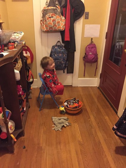 Child waiting at door to hand out Halloween candy