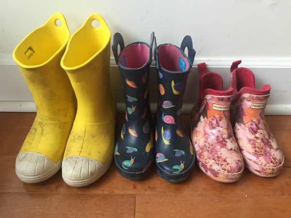Kids rain boots from Crocs and Hunter and Target lined up in a row