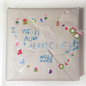 Present wrapped in packing paper decorated by young child