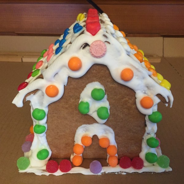 Gingerbread house decorated with frosting and assorted candy