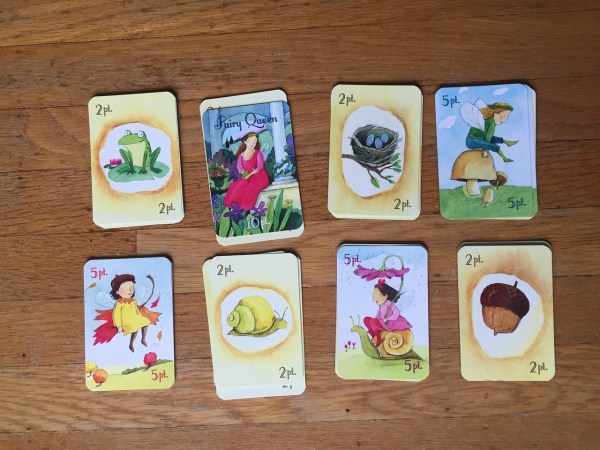 Fairy queen card game eeBoo stacks of cards on wooden floor illustrations