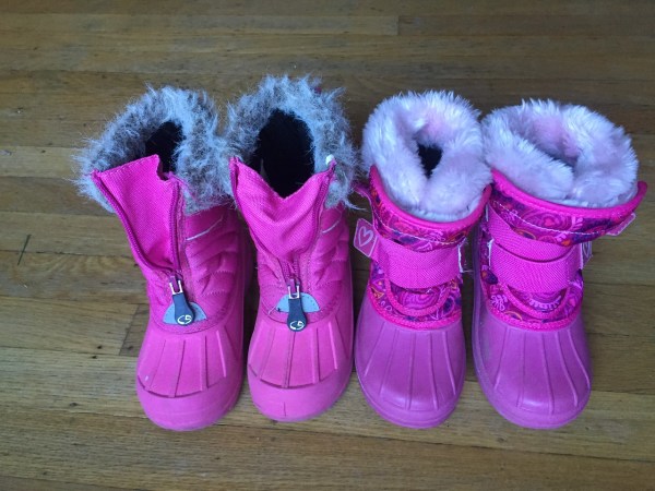 Two pairs of pink kids snow boots lined up on hardwood floor CG Kids and Champion Thermalite with Velcro