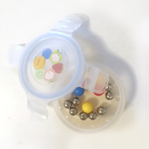 marbles from q ba maze and other marble run inside Innobaby clear round baby food snack container with lid