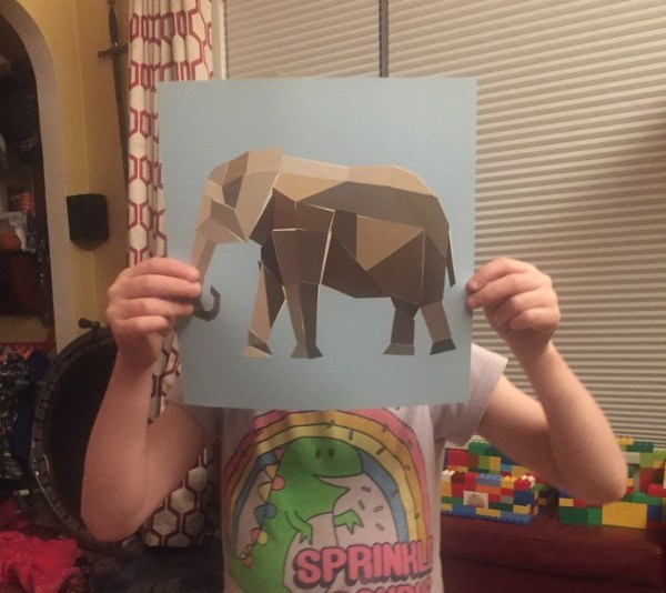 Paint by Stickers elephant page finished held up by girl child