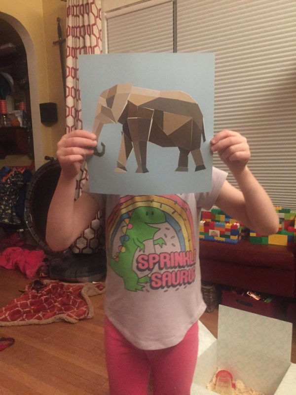 Paint by Stickers elephant page finished held up by girl child