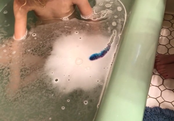 Bella Grace Bath Company rainbow bath fizzy starts to show color in bath water