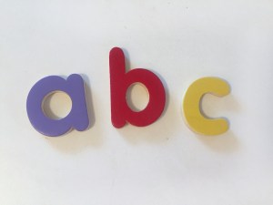 wooden lowercase letters a b c on white background