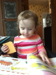 Toddler looking at Cars and Trucks and Things That Go book by Richard Scarry