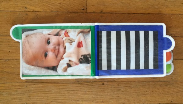 Sassy Look Photo Book album for infants inside with one photo and one empty slot with black and white background