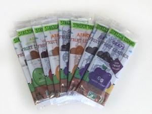 Variety of Stretch Island fruit leather flavors fanned out on white counter