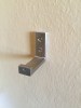 IKEA Bjarnum folding wall hook mounted on wall and unfloded
