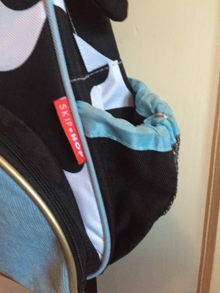 Side mesh pocket on Skip Hop little kids cow backpack perfect for holding water bottle or sippy cup