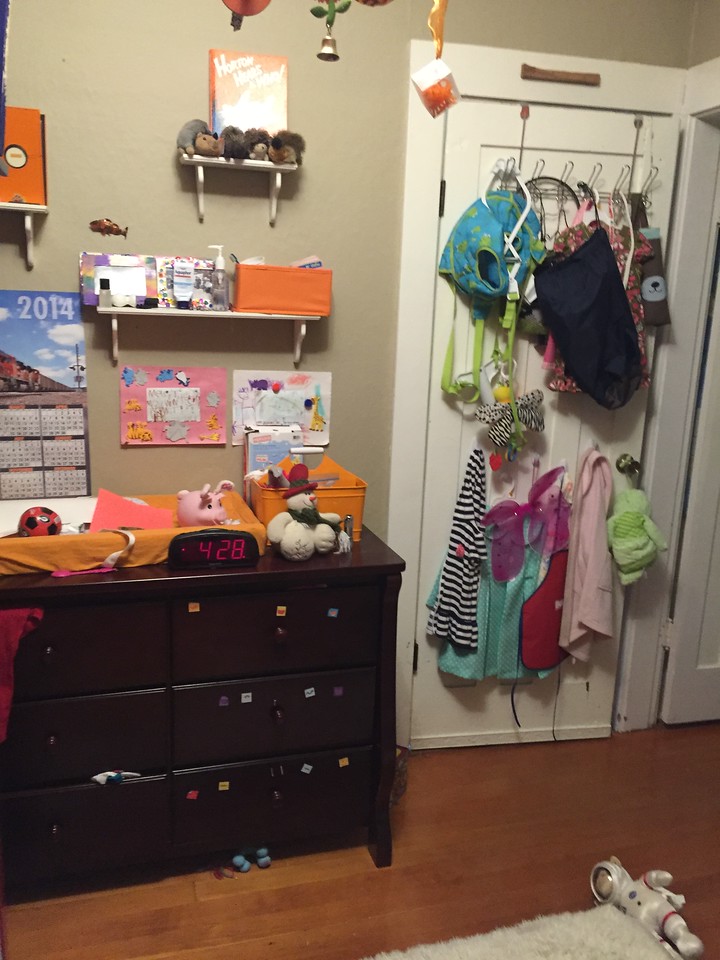 Dresser set up for changing diapers with open shelving above