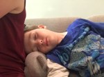 Child sleeping sideways on sofa next to adult passed out kid