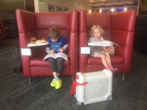 JetKids BedBox with two kids in airport lounger