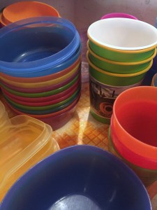 Stacks of brightly colored kids dishes cups and bowls