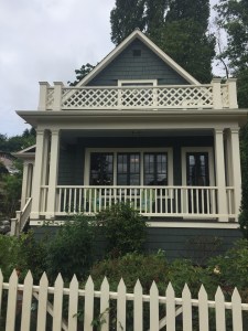 White picket fence and house with white railing