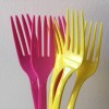 Pink and yellow plastic disposable forks