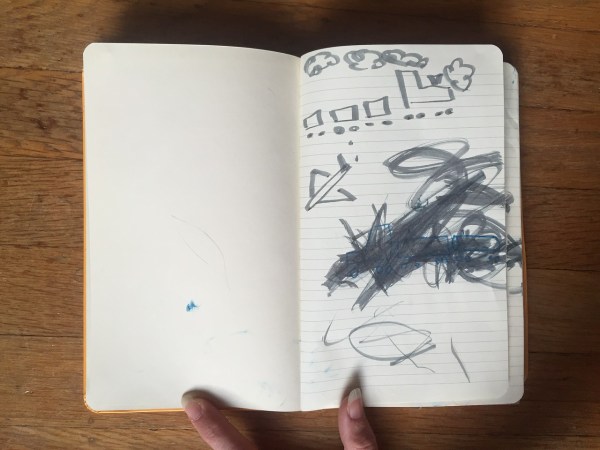 Child's drawing and coloring inside moleskin journal