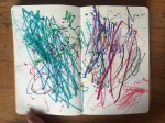 Child's scribbles inside lined moleskin journal