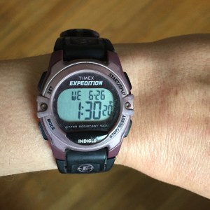 Stopwatch on wrist displaying time and date
