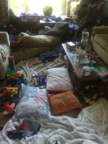 Messy living room kids pillows bedding and toys everywhere