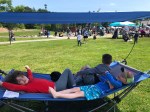 Mac Sports Fold Up Portable Hammock with Shade in blue and gray set up at park festival sunshine