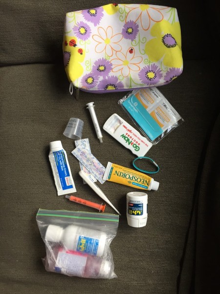 Flower bag with medicine for travel spread out around it