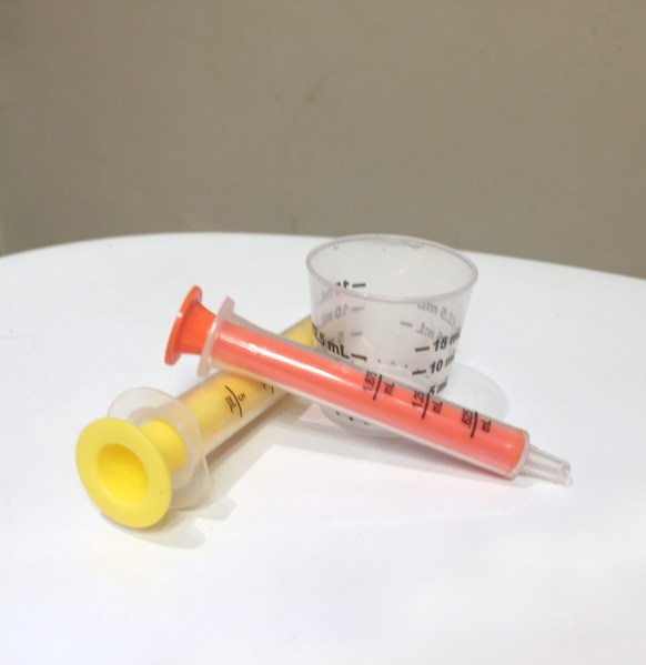 Advil Motrin children's liquid medicine measuring cups and syringes