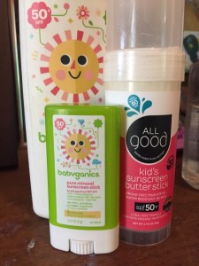 Babyganics SPF 50 sunscreen stick, lotion spray, and All Good Kids sunscreen butter stick