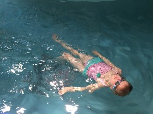 Child swimming wearing Aqua2ude goggles in swimming pool