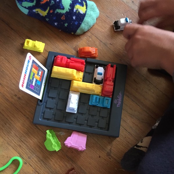 Kids playing Rush Hour Junior logic game puzzle from ThinkFun