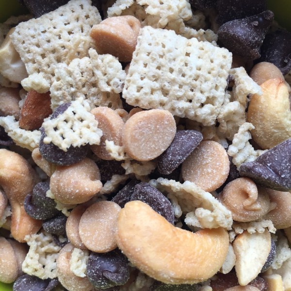 Snack mix close up with Rice Chex cashews almonds chocolate chips and peanut butter chips