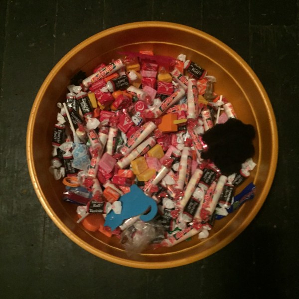 Halloween bowl filled with candy and goodies