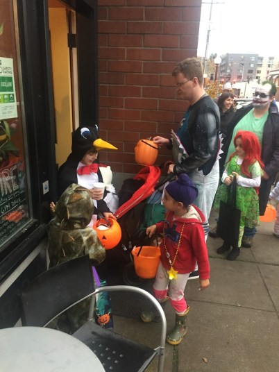Kids trick or treating in business district