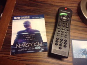 Remote control next to HBO advertisement on coffee table