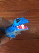 Blue lizard kids' animal flashlight with lightbulb in mouth lit up