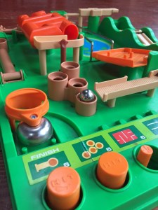 Run Yourself Ragged Screwball Scramble game green plastic board with orange accents marble challenge game