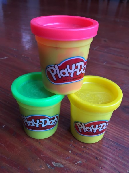 Medium containers of Play-Doh modeling dough compound stacked in pyramid