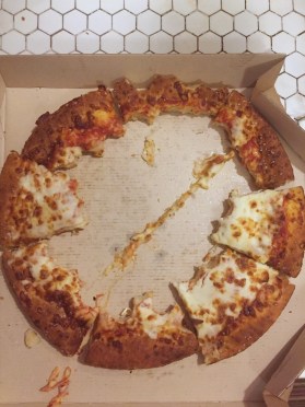 Cheese pizza crust left behind with middle of pizza missing after kids eat