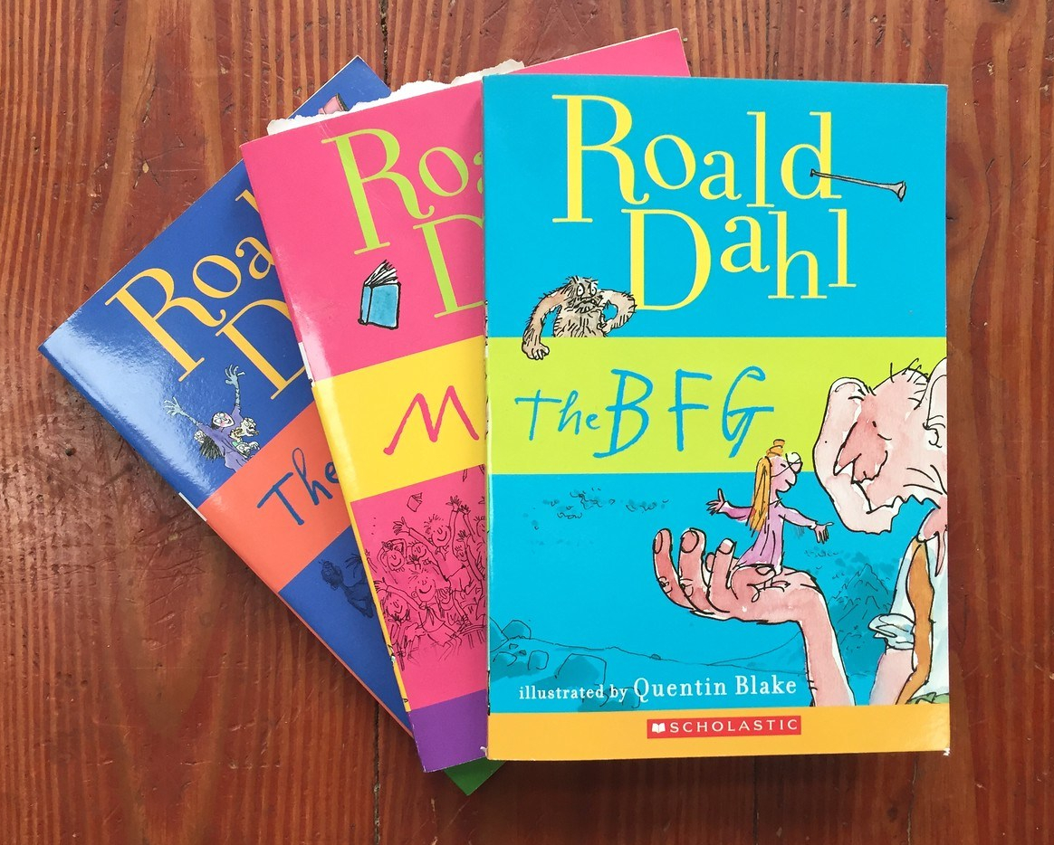 Roald Dahl books for kids The BFG Matilda and The Witches in fanned stack on hardwood floor