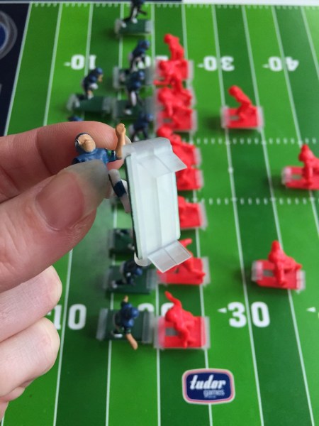 Plastic cleats on the bottom of NFL team figure from electric football game